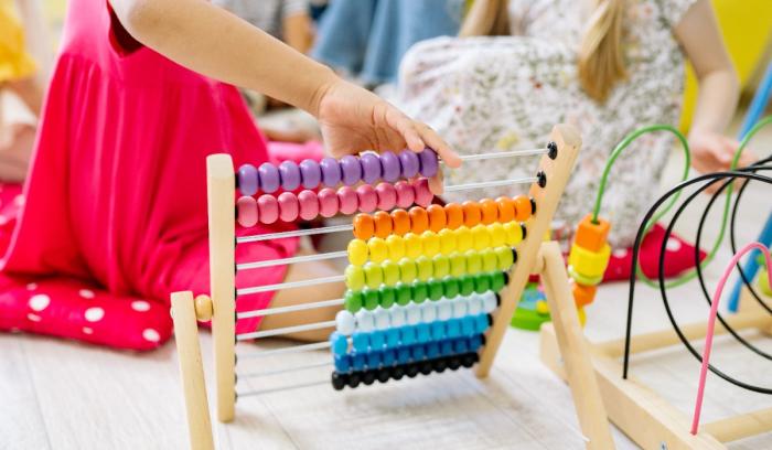 Children exploring numbers with an abacus toy